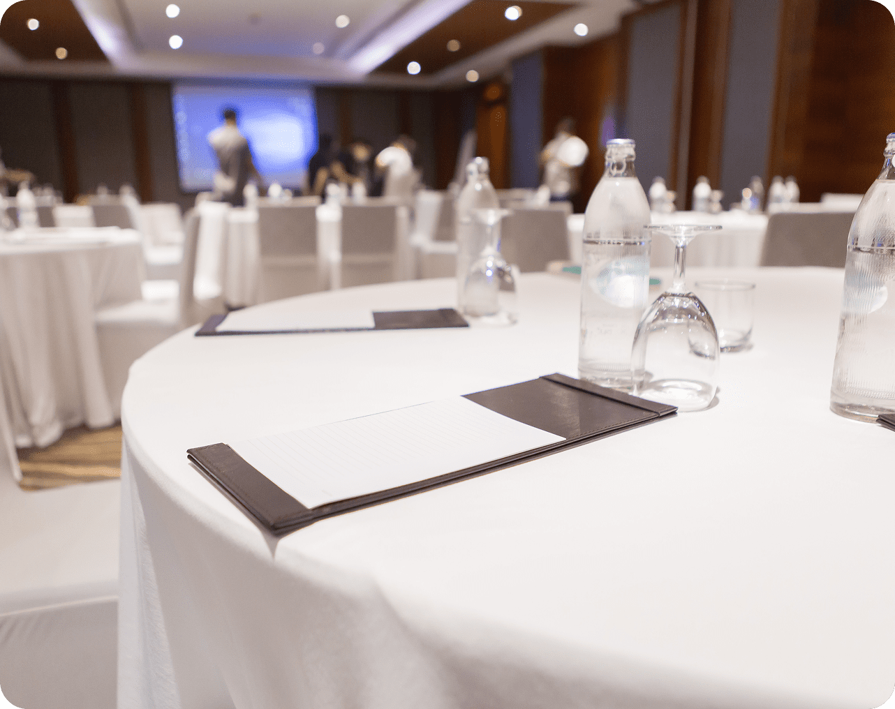 Blurred event room with white tablecloths